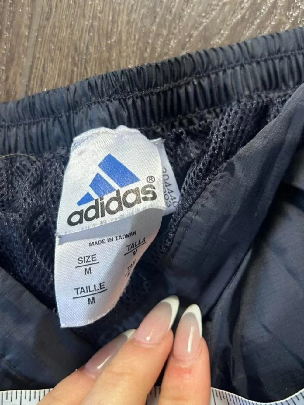 Adidas navy track pants with yellow stripes and zipper pockets size medium
